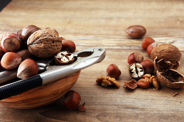Large diversity of healthy nuts in wooden bowl.
