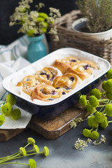 sweet homemade pastries with berries and chocolate. in a blue tray