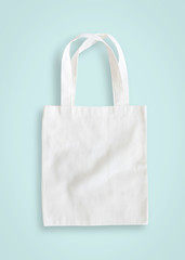 Tote bag mock up canvas fabric cloth shopping sack on blue background isolated with clipping path