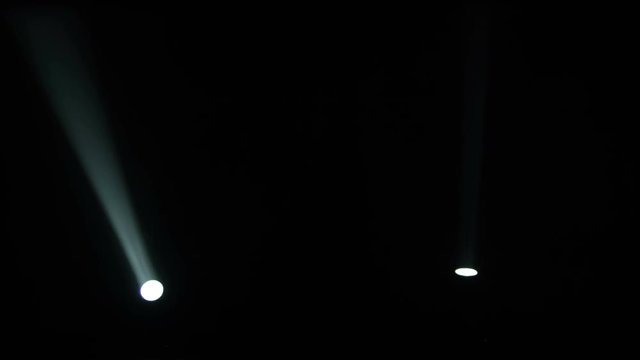 Realistic footage of stage light flashing rays spotlights through smoke. Great as a natural stage background for different projects!!!