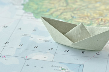 Immigration and ask for asylum concept - paper boat on a map - obrazy, fototapety, plakaty
