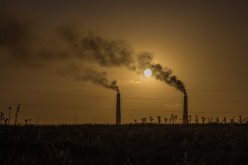 Industrial smoke from chimney at sunset, steppe near Almaty, Kazakhstan