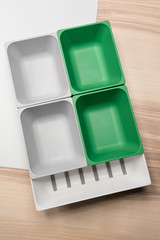 Green and grey plastic trays arrangement. Multi-purpose kitchenware collection