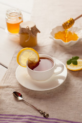 tray with honey and a cup of hot tea, lazy morning, warm winter mood