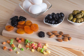 Olives, eggs, juice and other products on the table, healthy meals