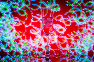 A glass of champagne with ice in the background of the fireworks. The flash created by the spinner...