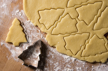 gingerbread pastry with christmas tree shape on a wooden table close up.holiday background, christmas biscuits with love