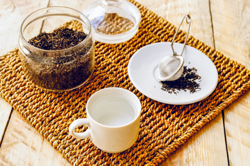 tea set with hot water in cup on wooden table