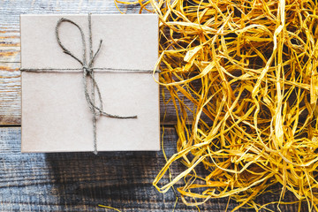 craft gift box on wooden table with raffia or twine
