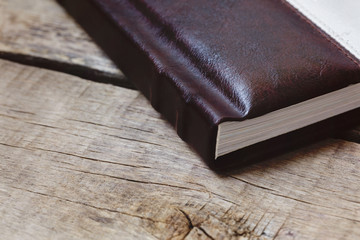Photo album, photobook memories on a wooden table.