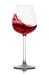 moving red wine glass over a white background