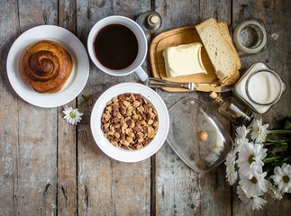 variety on the morning table - flakes, buns, coffee, bread and butter