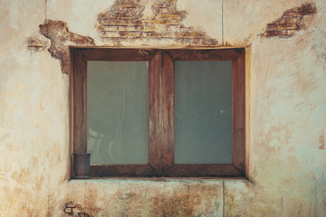Close up vintage retro wooden window on old grunge brick wall.
