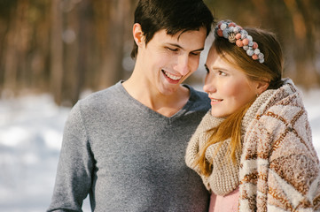 Young loving couple having fun in snowy park