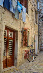  The Steep streets of Rovinj old town with bicycle and washing line, Croatia.
