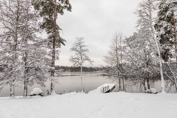 The first snow in autumn in Finland. City of Tampere, lake and forest,nature trail, nature photography. Travel.