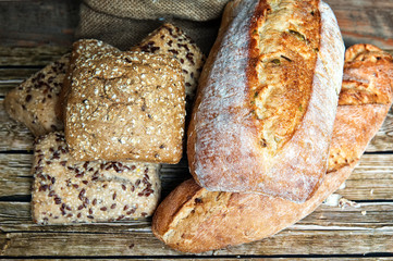Freshly baked homemade bread on rustic wooden background.