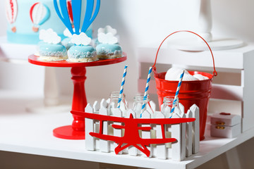 Candy bar on boy's birthday party with a lot of different candies, popcorn, beverages and big cake....