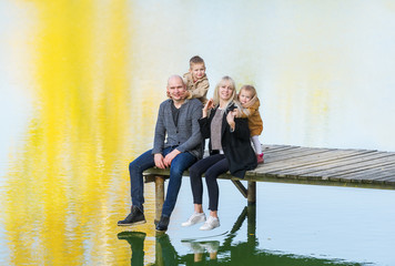 Family enjoying autumn by the lake
