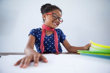Smiling girl as businesswoman looking at files - obrazy, fototapety, plakaty