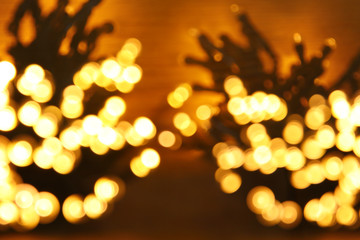 glitter garland lights background. gold and black. de-focused.