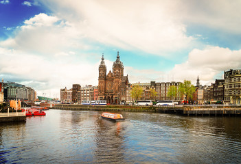 Amsterdam skyline with Church of St Nicholas over old town canal, Amsterdam, Holland, retro toned
