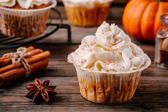 Pumpkin cupcakes decorated with cream cheese frosting