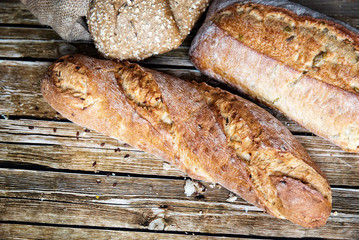 Freshly baked homemade bread on rustic wooden background.