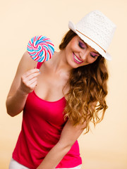 Woman holds colorful lollipop candy in hand