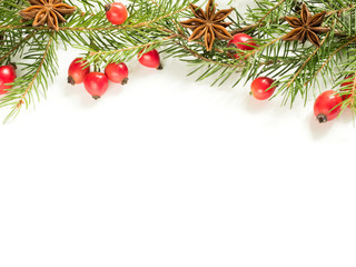 Christmas decorations on a white background, berries rose hips, stars, fir branches. copy space