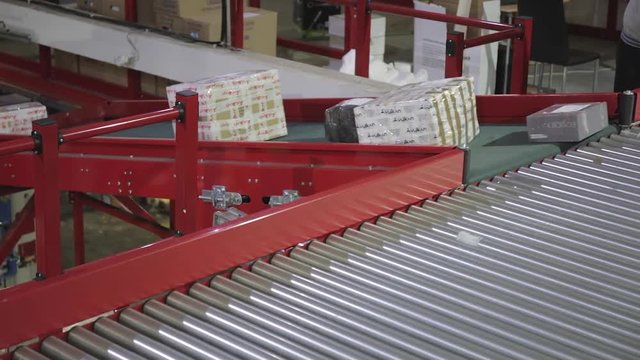 Fast Packages at Conveyor Rollers in Sorting Warehouse