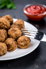 Meatballs on a vintage looking slate slab (selective focus)