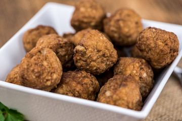 Vintage wooden table with Meatballs (selective focus; close-up shot)