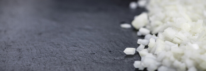 Diced white onions on a slate slab, selective focus