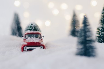 Toy pickup car carrying Christmas tree