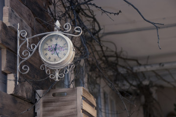 vintage wall clock on a wooden wall