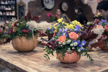 bunch of Rowan berries flowers roses in a pumpkin