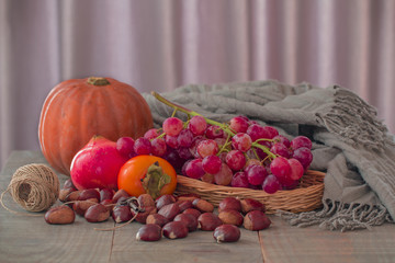 Some autumnal frutis and a grey wool scarf.