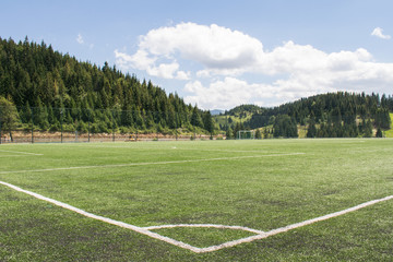 Sports ground in mountains, focus on soccer field © Catalin