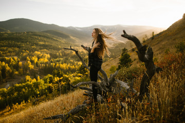 Mindfulness Woman With Long Hair Blowing in the Wind on a Mountain