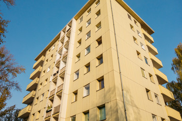 orange plattenbau building in autumn