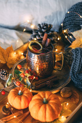 Glass of hot steaming tea and autumn plants