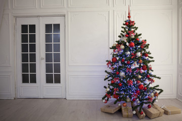 new year tree in the room with Christmas gifts