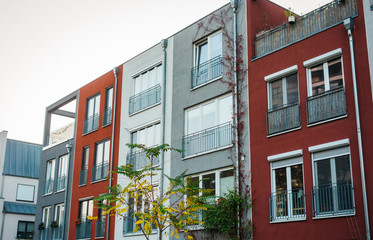 Obraz premium townhouses with different facades in color red, white and grey
