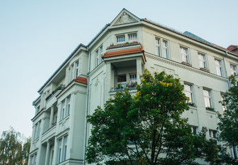 Fototapeta na wymiar grey old apartment building in vintage colors