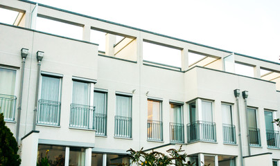 modern white townhouses with blue windows and modern roof