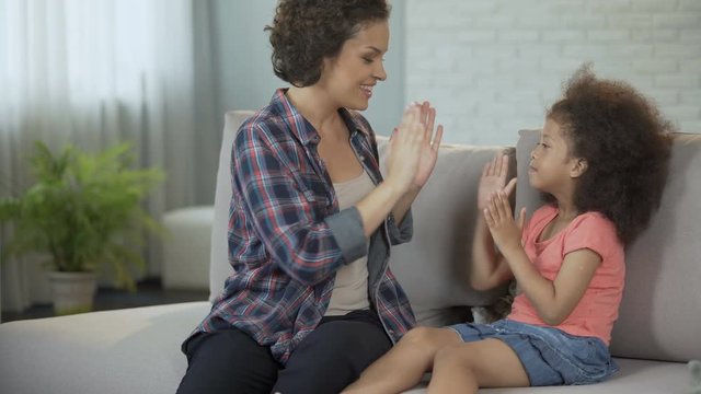 Girls having fun tickling each other and gaming to develop fine motor skills