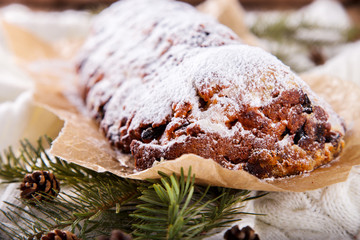 Dresdner Stollen is a Traditional German Cake with raisins on a light knitted background.Gift for Christmas.Vintage style.Fruit cake for the Holiday.