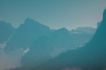 View of reflection of mountain in lake during foggy weather