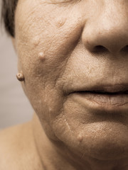 Elderly pensioner female half face portrait closeup